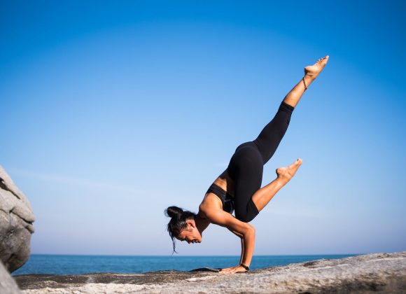 Low Angle View of Woman Relaxing on Beach Against Blue Sky