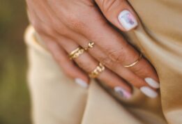 person wearing gold ring with blue stone